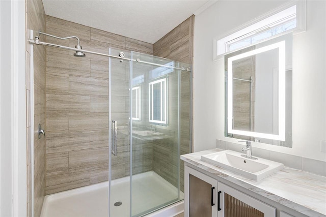 bathroom featuring vanity and a shower with door