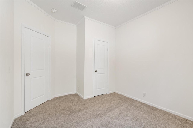 unfurnished bedroom with ornamental molding and light colored carpet