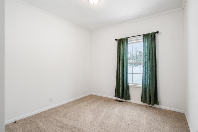 empty room featuring ornamental molding and carpet flooring