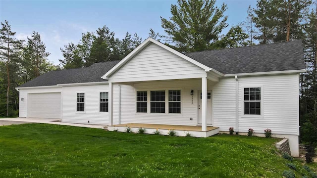 view of front of home with a garage, a porch, and a front lawn