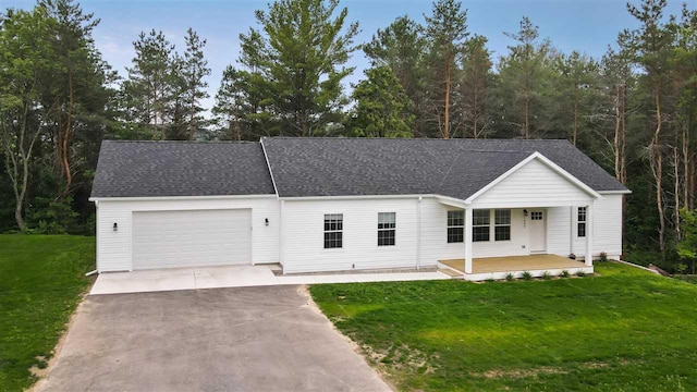 single story home with a garage, a front yard, and a porch