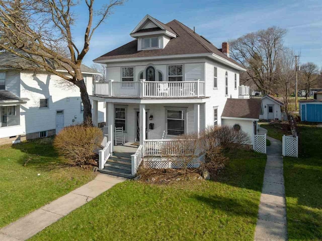 view of front of house featuring a balcony, a porch, and a front lawn