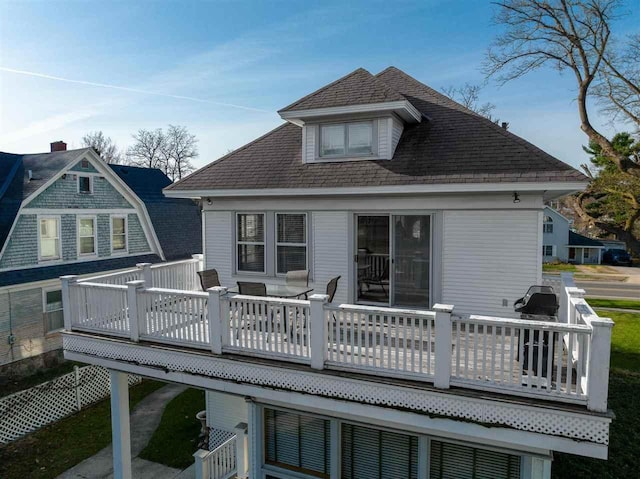 rear view of property with a wooden deck