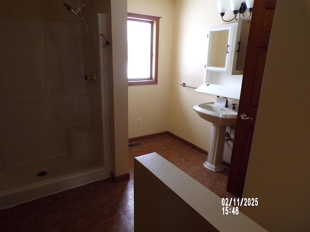 bathroom with sink and walk in shower