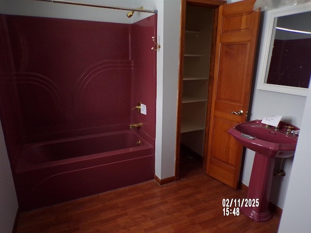 bathroom featuring hardwood / wood-style flooring and bathtub / shower combination