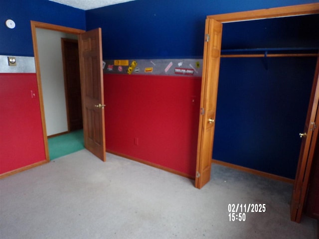 unfurnished bedroom with light carpet and a closet