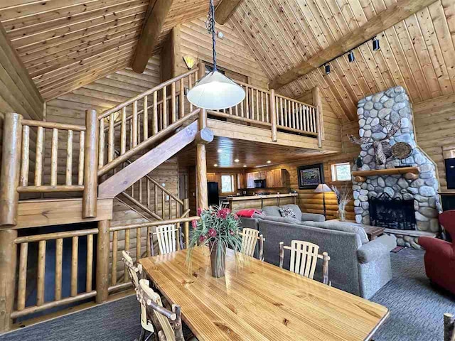 dining room with beam ceiling, high vaulted ceiling, wooden ceiling, and a fireplace