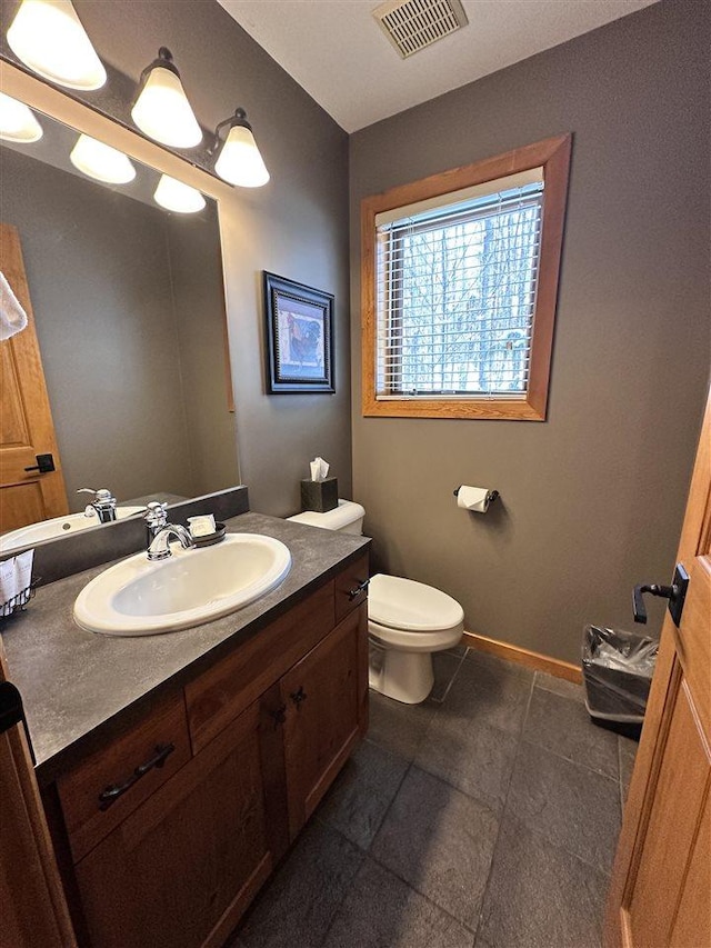 bathroom with vanity and toilet