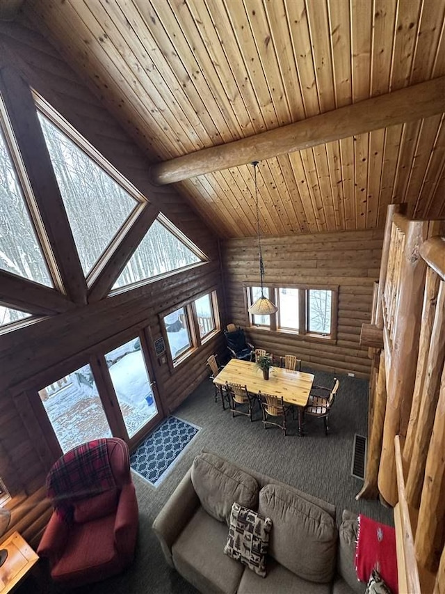 carpeted living room with beamed ceiling, wood ceiling, high vaulted ceiling, and log walls