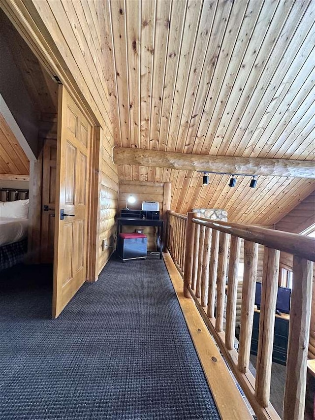 hallway with beam ceiling, wood ceiling, and rustic walls