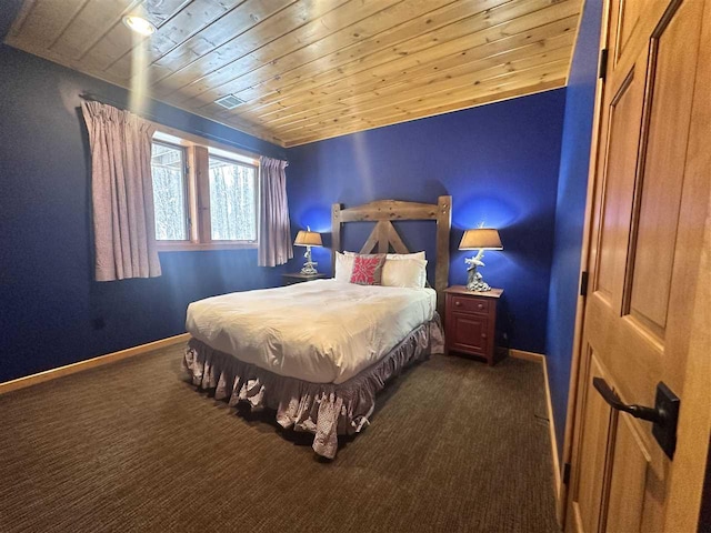 bedroom with wood ceiling and dark carpet