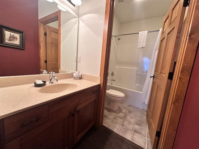 full bathroom with vanity, tile patterned floors, toilet, and washtub / shower combination