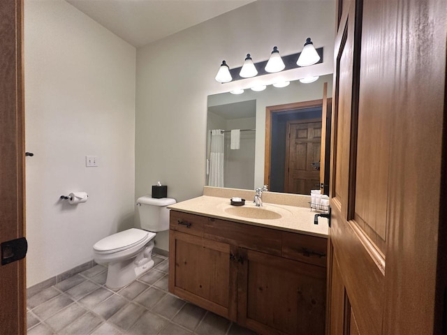 bathroom featuring vanity, tile patterned flooring, and toilet