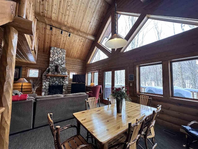 dining area with a stone fireplace, rustic walls, high vaulted ceiling, wooden ceiling, and beamed ceiling