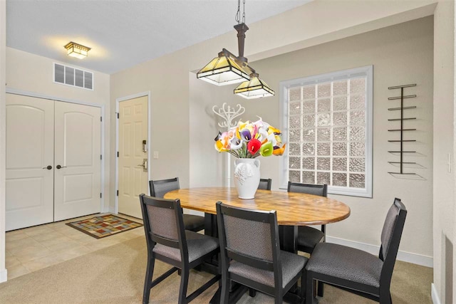 dining room featuring light carpet