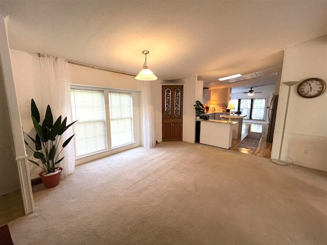 unfurnished living room featuring light colored carpet