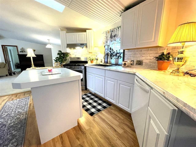 kitchen featuring light hardwood / wood-style flooring, gas stove, sink, dishwasher, and white cabinets