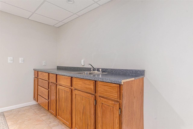 kitchen featuring sink and a paneled ceiling