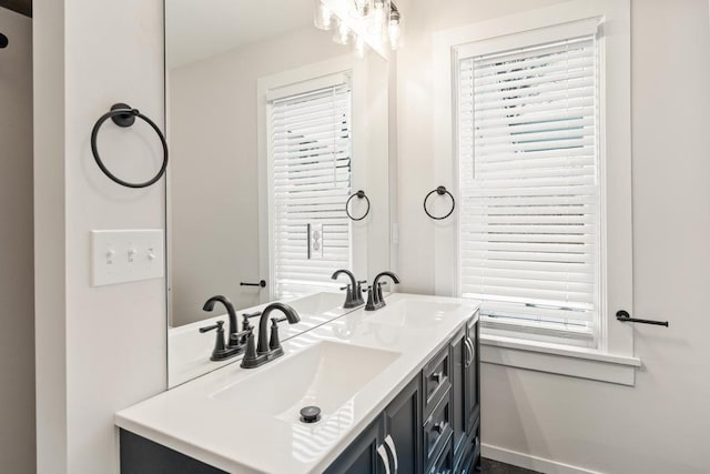 bathroom featuring a sink and double vanity