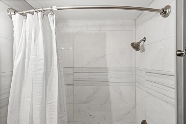 bathroom with tiled shower