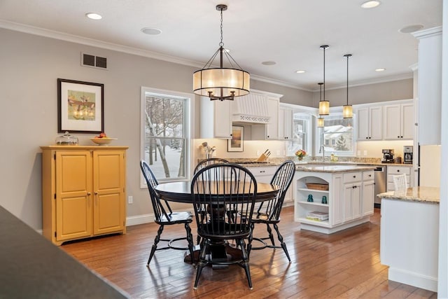 2632 Woodside Dr, Petoskey, MI 49770 - dining room with light wood-style floors and ornamental molding
