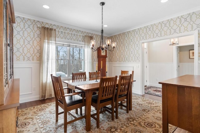 2632 Woodside Dr, Petoskey, MI 49770 - dining area featuring ornamental molding, wood finished floors, a wainscoted wall, and wallpapered walls