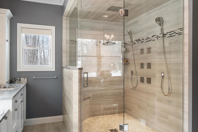 2632 Woodside Dr, Petoskey, MI 49770 - bathroom featuring a shower stall, vanity, and baseboards