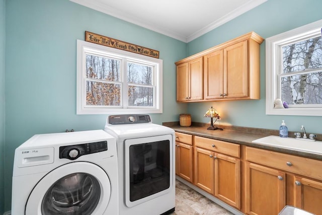 2632 Woodside Dr, Petoskey, MI 49770 - washroom featuring ornamental molding, washer and dryer, cabinet space, and a sink
