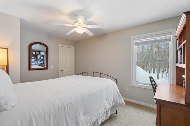 2632 Woodside Dr, Petoskey, MI 49770 - bedroom with light colored carpet, ceiling fan, and baseboards