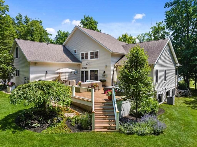 back of property featuring a yard, a shingled roof, central AC unit, a deck, and stairs