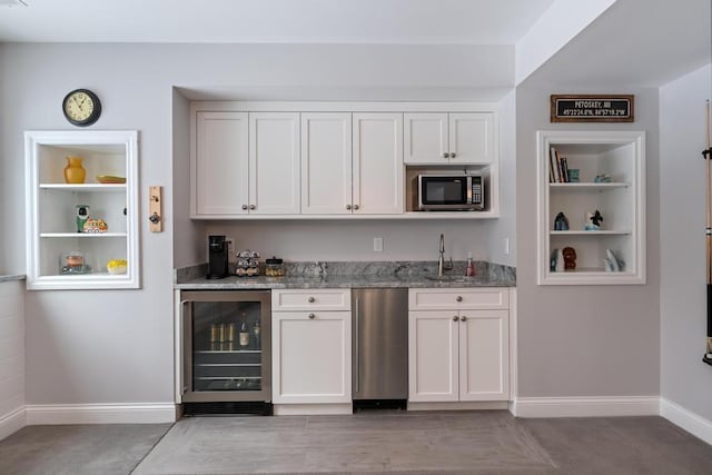 2632 Woodside Dr, Petoskey, MI 49770 - bar featuring baseboards, built in features, wine cooler, stainless steel microwave, and wet bar