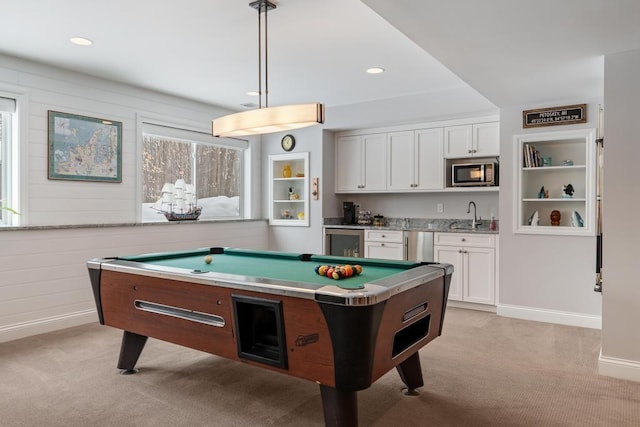 2632 Woodside Dr, Petoskey, MI 49770 - rec room featuring wine cooler, recessed lighting, light carpet, a sink, and baseboards