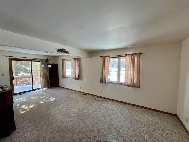 carpeted empty room with baseboards and a healthy amount of sunlight