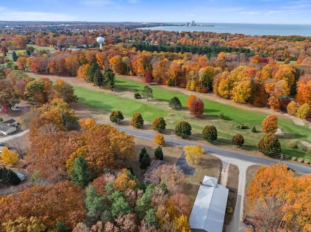 drone / aerial view featuring view of golf course and a water view