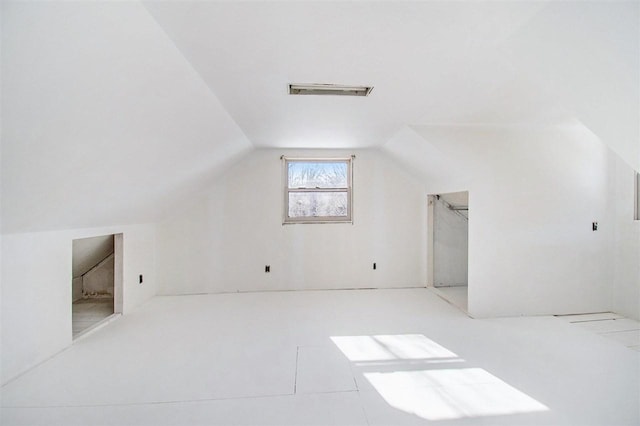 additional living space featuring lofted ceiling