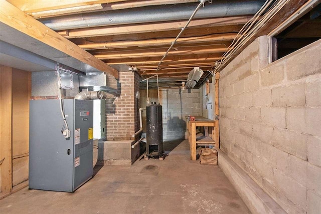 unfinished below grade area with heating unit and water heater