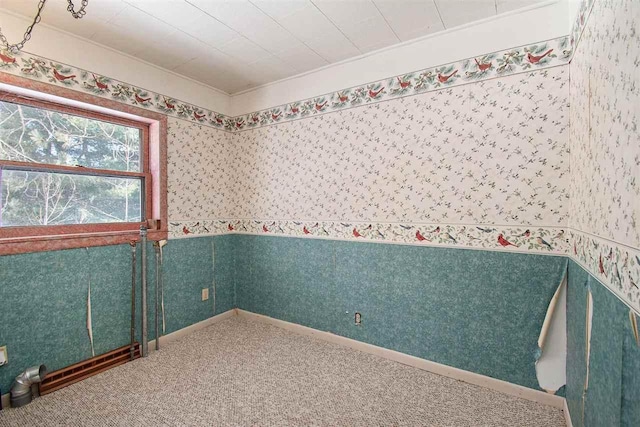 unfurnished room featuring carpet, baseboards, and wallpapered walls