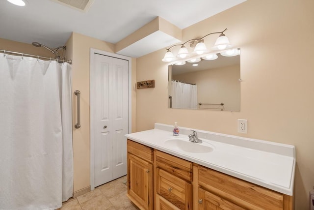 bathroom with tile patterned flooring, a closet, visible vents, and vanity