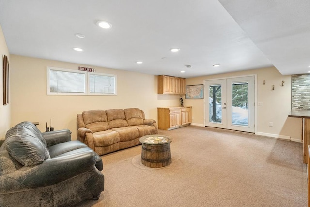 living area featuring light carpet, french doors, recessed lighting, and baseboards