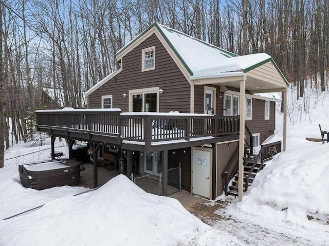 view of front of property with a garage, a wooden deck, and stairs