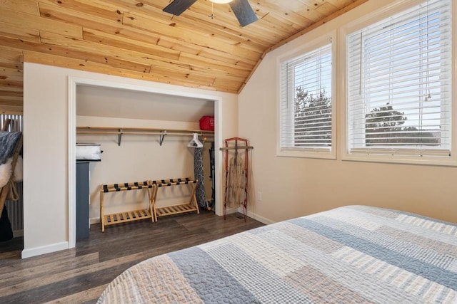 bedroom featuring baseboards, dark wood finished floors, wooden ceiling, vaulted ceiling, and a closet