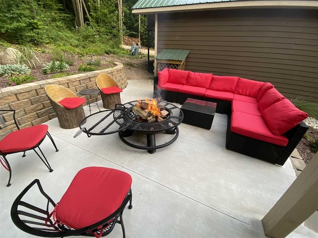 view of patio / terrace with an outdoor living space with a fire pit