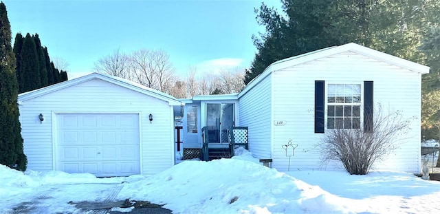 exterior space with a garage and an outbuilding