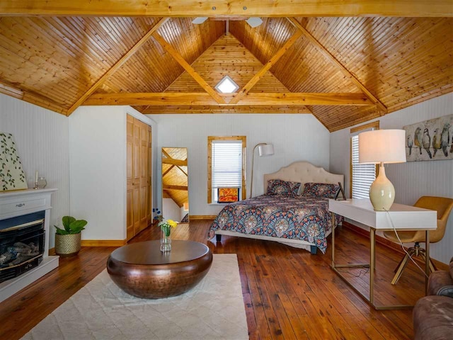 bedroom featuring wooden ceiling, hardwood / wood-style flooring, vaulted ceiling with beams, and a fireplace with raised hearth