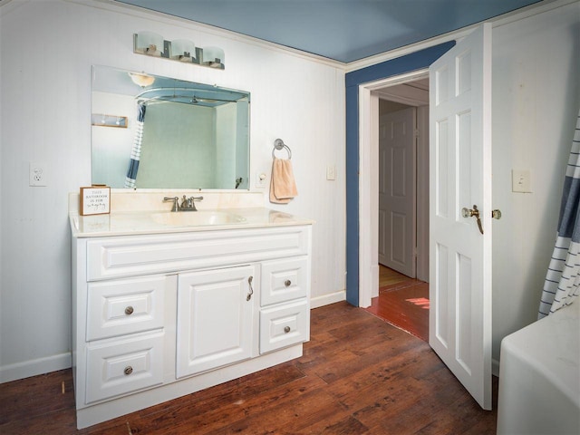 bathroom with vanity, baseboards, and wood finished floors