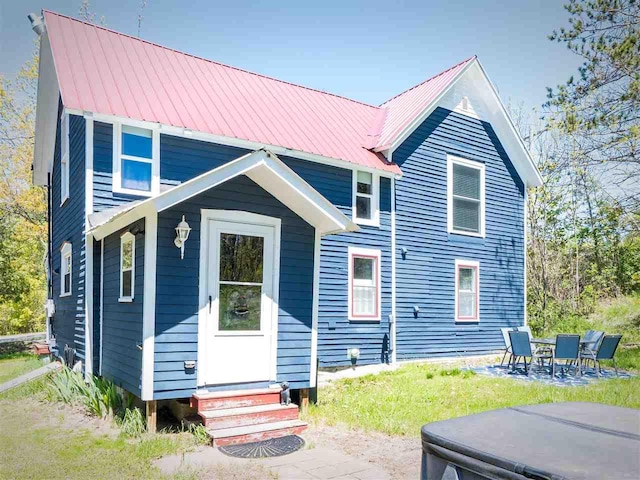 8102 Upper Bay Shore Rd, Charlevoix, MI 49720 - rear view of property with entry steps, metal roof, and a patio area