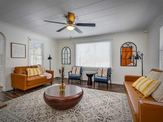 sitting room with arched walkways, ornamental molding, and a wealth of natural light