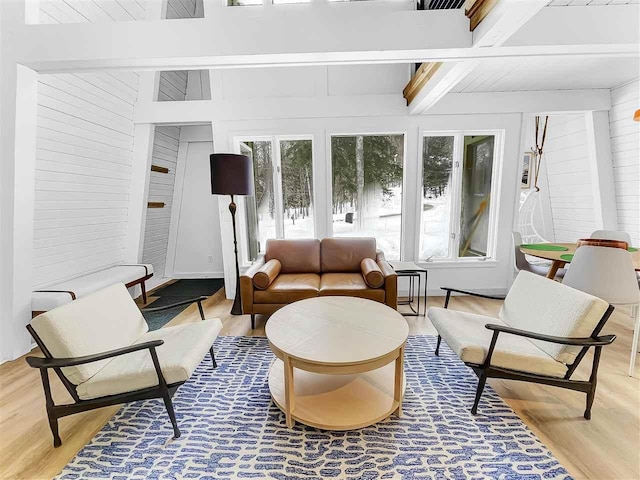 sunroom with plenty of natural light and beamed ceiling