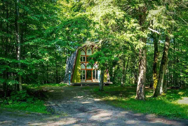 exterior space featuring a forest view