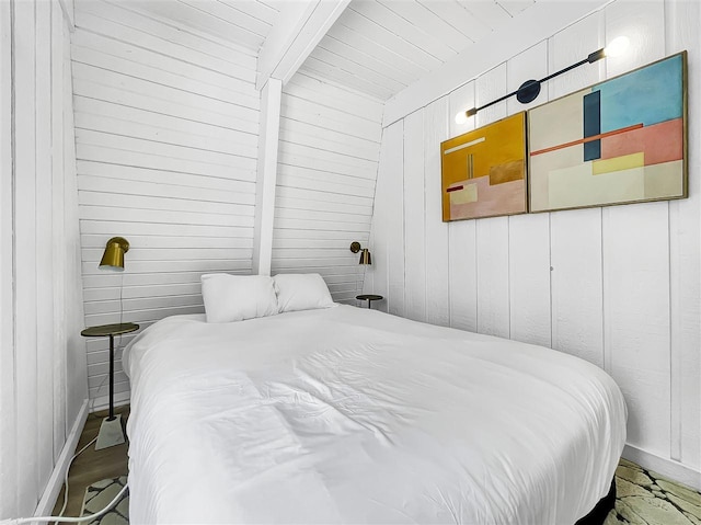 bedroom featuring wooden walls